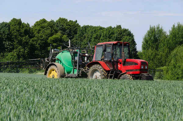 Farm machinery tractor long sprayer work in field