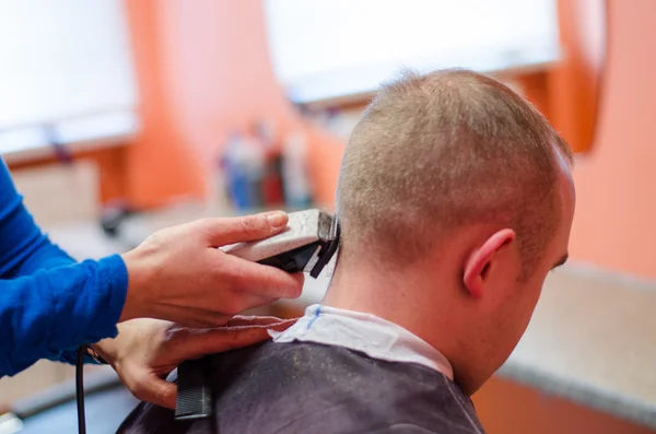 Hairdresser shape man haircut with clipper
