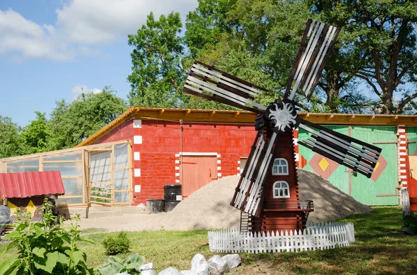 Colorful country yard mill in summer time