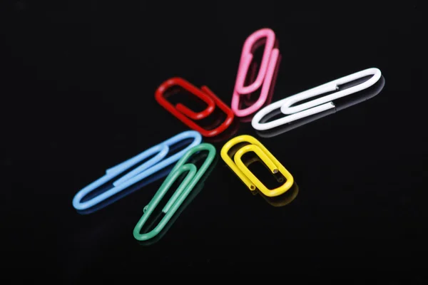 Photo of colorfull paper clips on a black background