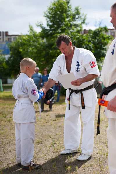 Presentation of a certificate and an orange belt