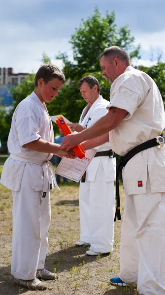 Presentation of a certificate and an orange belt