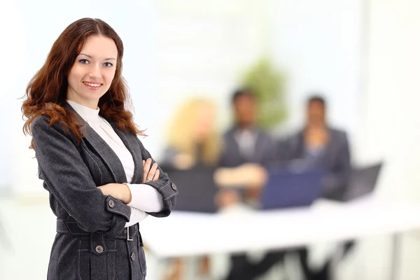 Beautiful businesswoman keeps the laptop. Isolated on a white background.