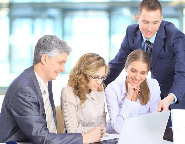 Smiling business with paper work in board room