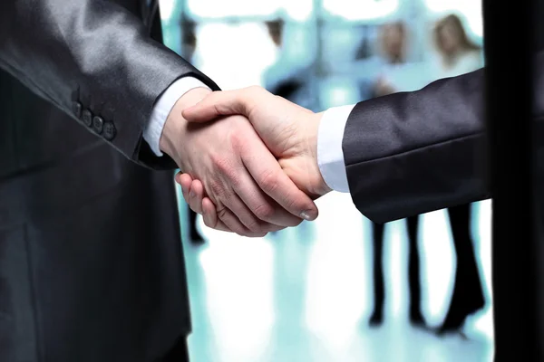 Close-up of business people shaking hands to confirm their partnership