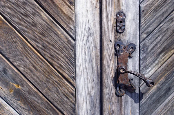 Old wooden door fragment with metal handle