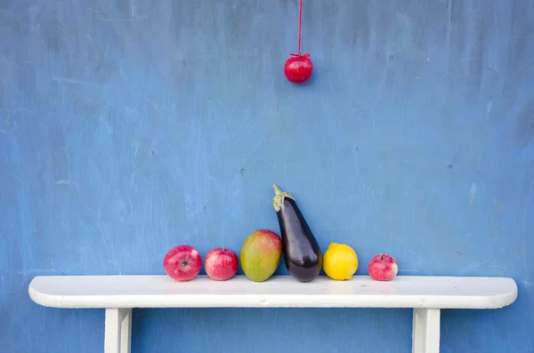 Fruits an vegetables on white wooden shelf