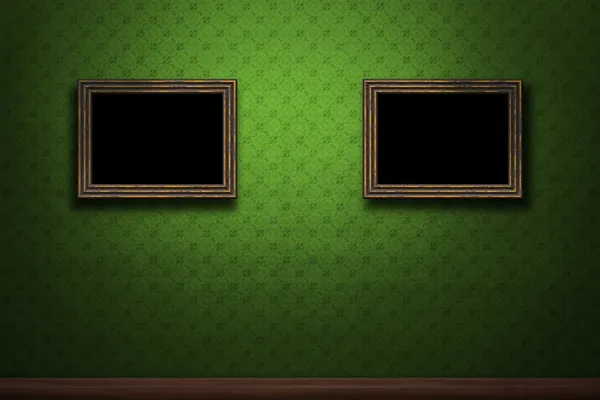 Old wooden frames on green retro grunge wall