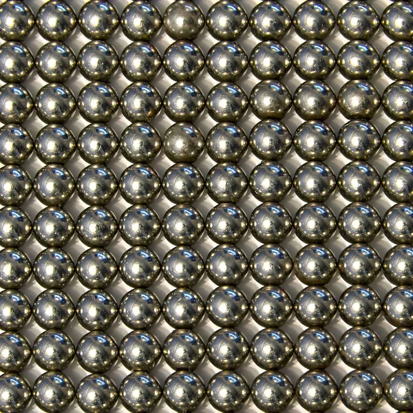 Background of small metal balls on a light background