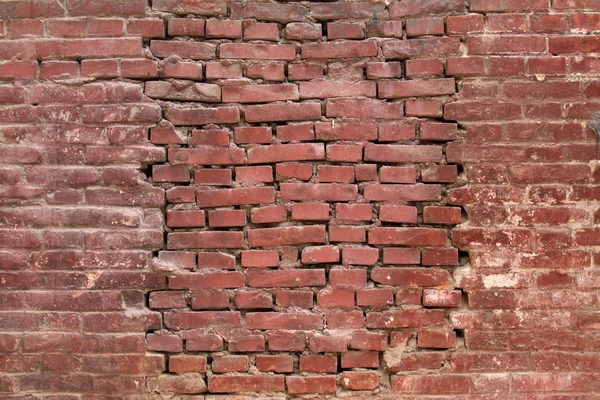 Broken brick wall in a street