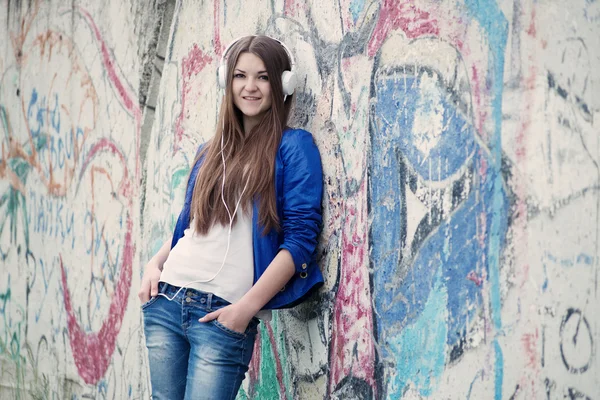 Trendy young woman listening to music