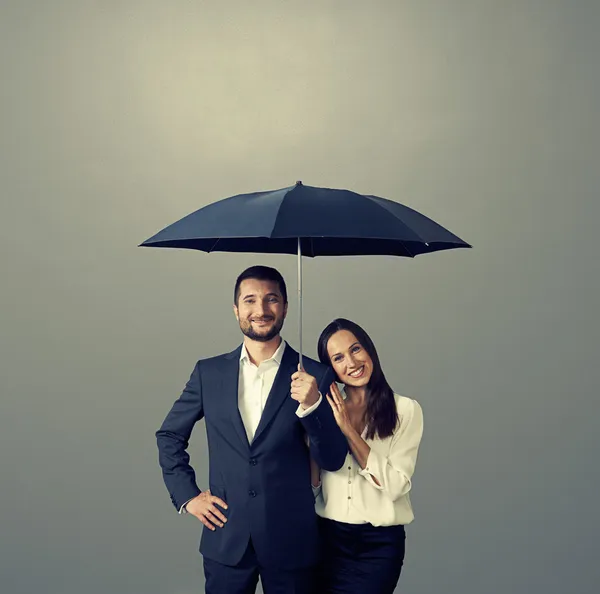 Smiley couple under umbrella