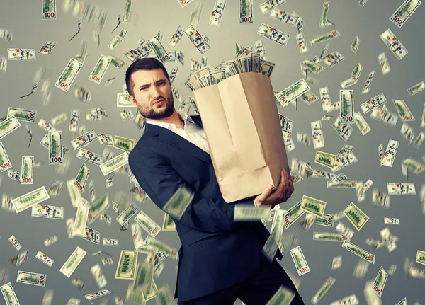 Handsome businessman holding money