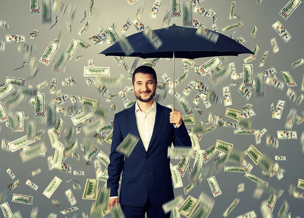 Smiley and glad man under money rain