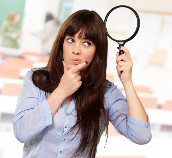 Portrait Of A Girl Holding A Magnifying Glass And Thinking