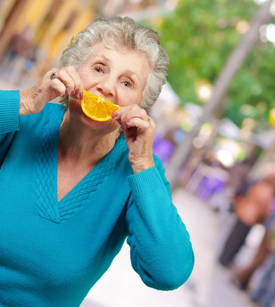 Mature Woman With A Slice Of Fruit