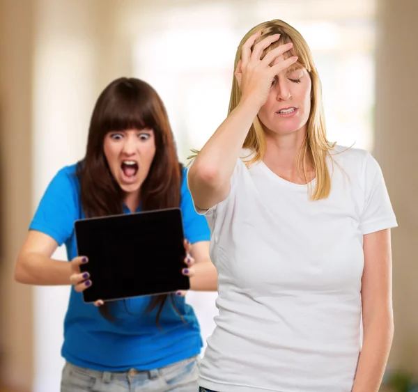 Frustrated Woman In Front Of Shocked Woman