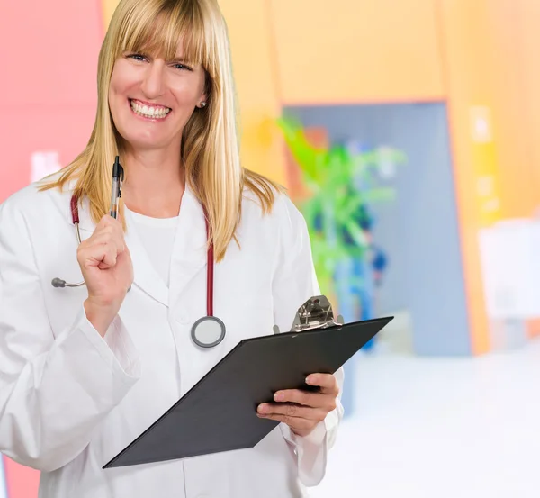 Happy female doctor holding a clipboard