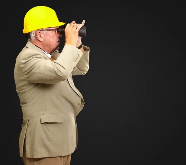 Senior Architect Looking Through Binoculars