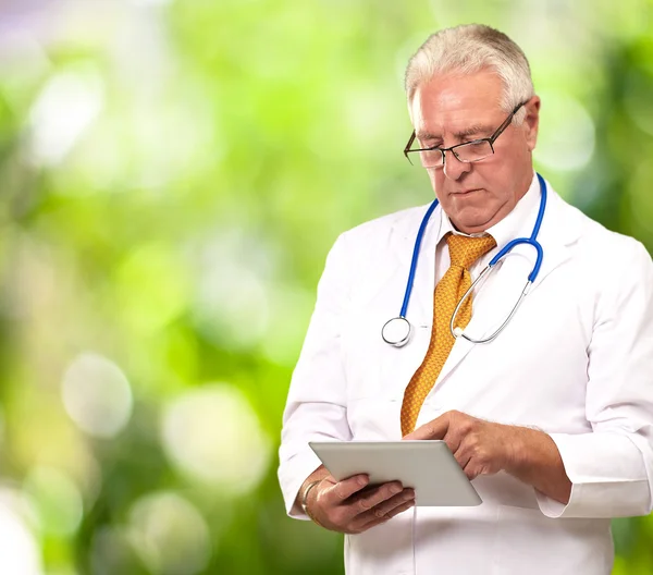 Portrait Of A Male Doctor Holding A Tab