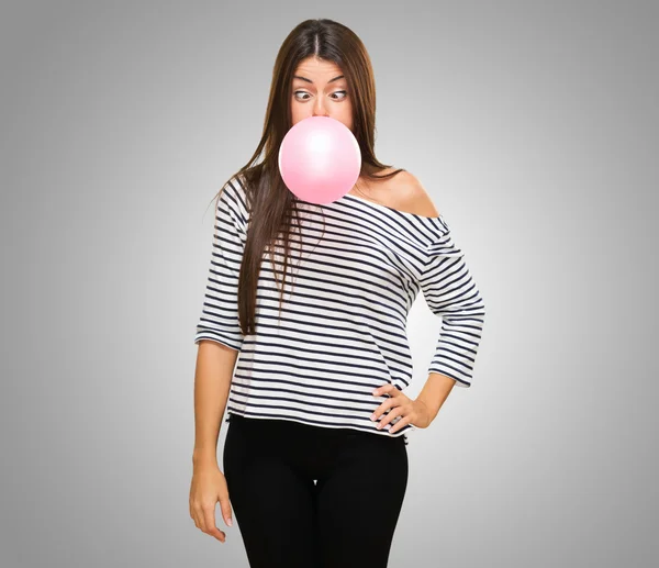 Young Woman Blowing Bubblegum and crossing her eyes