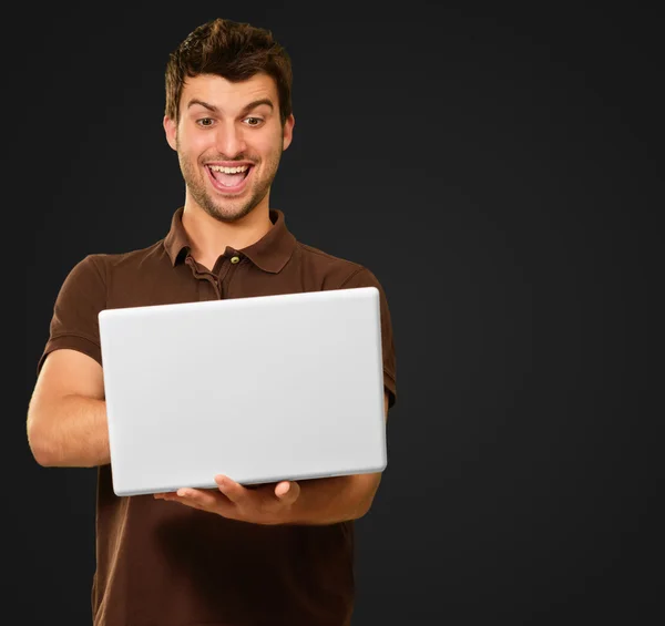 Happy Young Man Working On Laptop