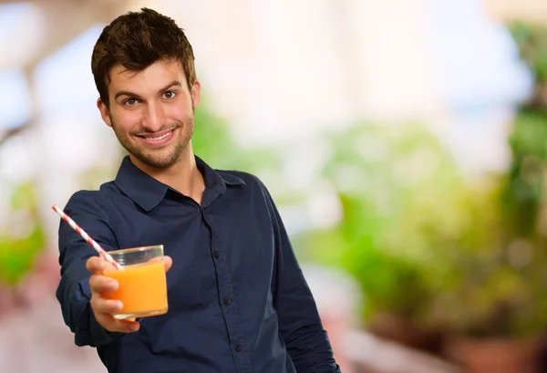 Young Man Holding Glass Of Orange Juice