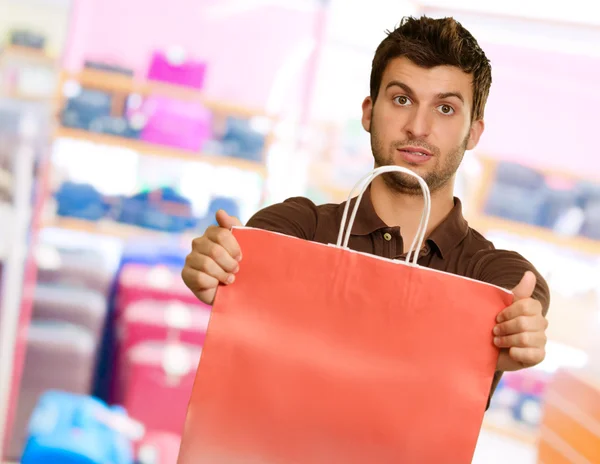 Young Man Holding Shopping Bag