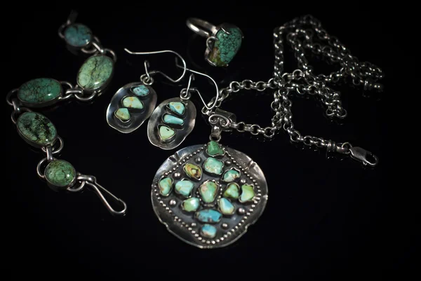Jewelry from silver and turquoise on black background