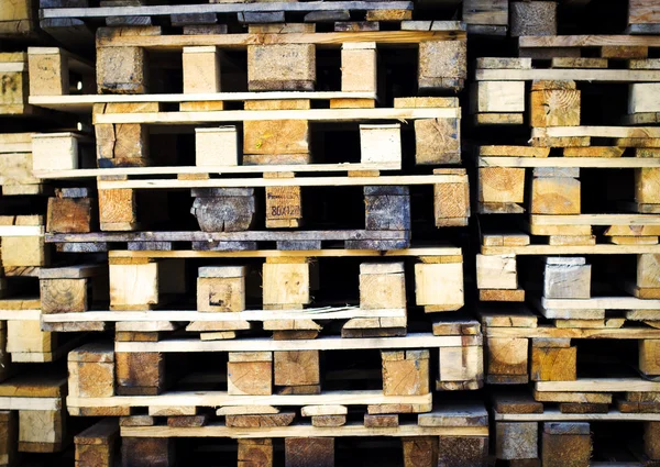 Piles of wooden aged pallets.