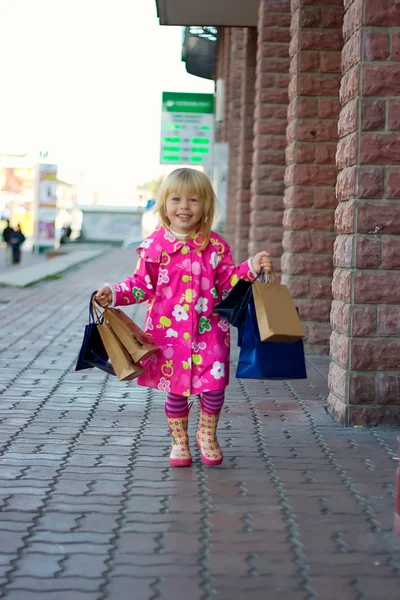3 years old girl down the street with shopping