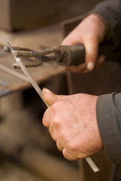 The hands of men working with a lever
