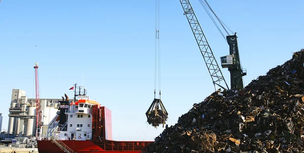 Crane scrap unloading a ship