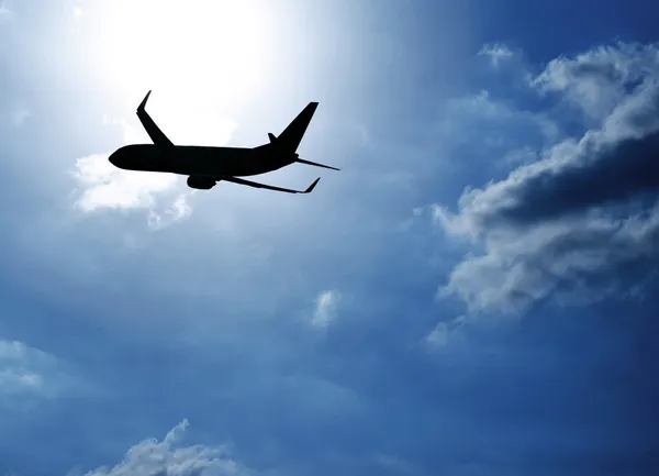 Silhouette airplane in blue sky
