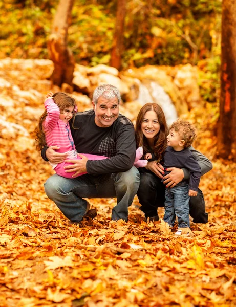 Happy family in autumn park
