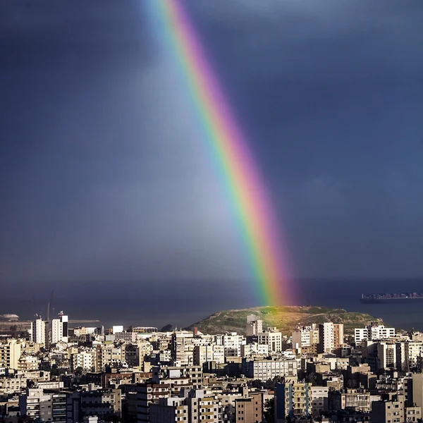 Bright rainbow over city