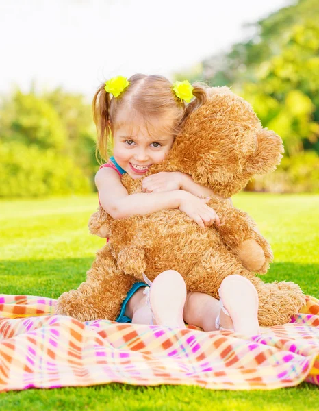Happy girl with teddy bear