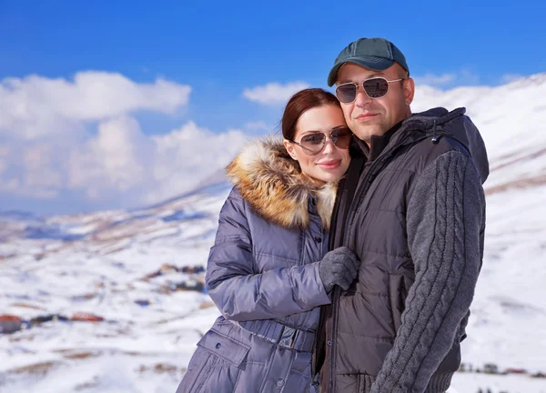 Happy family in winter mountains