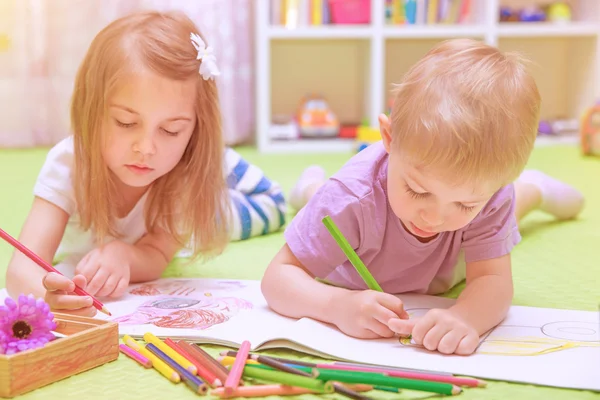 Happy baby boy & girl enjoying homework