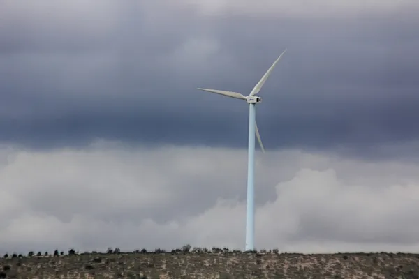 Wind energy windmills in a dark storm, electric generators