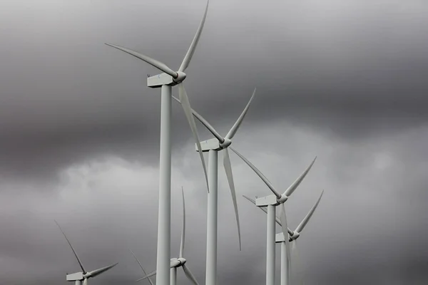 Wind energy windmills in a dark storm, electric generators