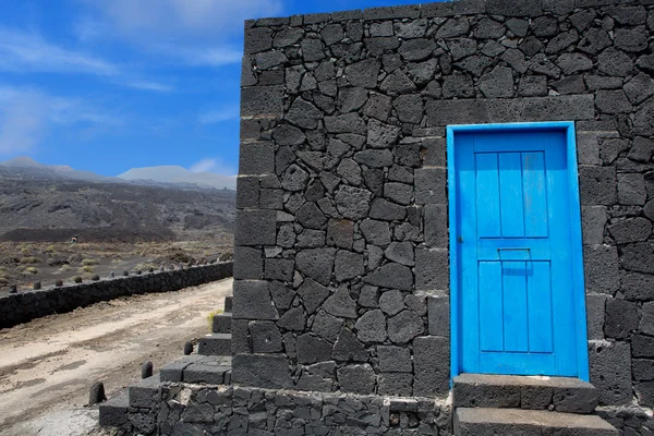 Blue door lava stone masonry wall at La Palma