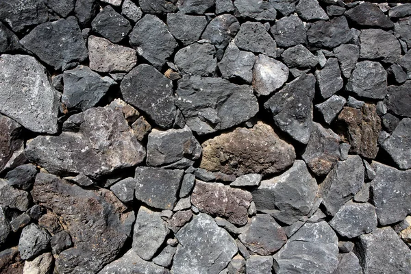 Black lava stone volcanic masonry wall