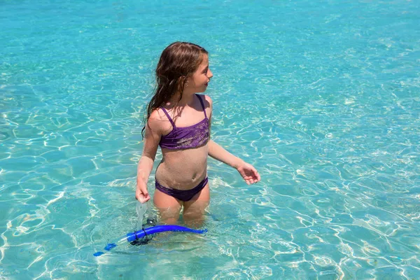 Aqua water beach and purple bikini little girl