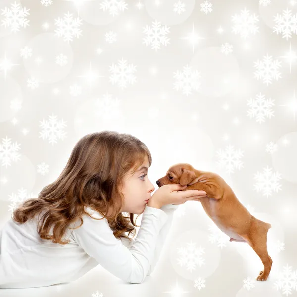 Christmas children girl hug a puppy brown dog