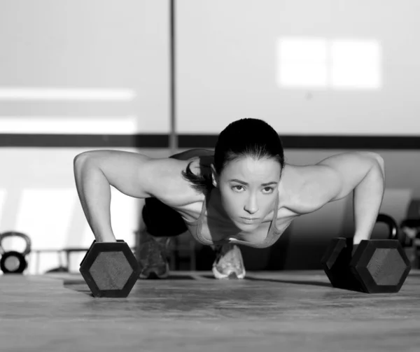 Gym woman push-up strength pushup with dumbbell