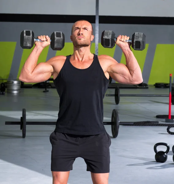 Gym man with dumbbells exercise crossfit