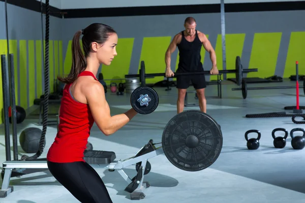 Girl dumbbell and man weight lifting bar workout