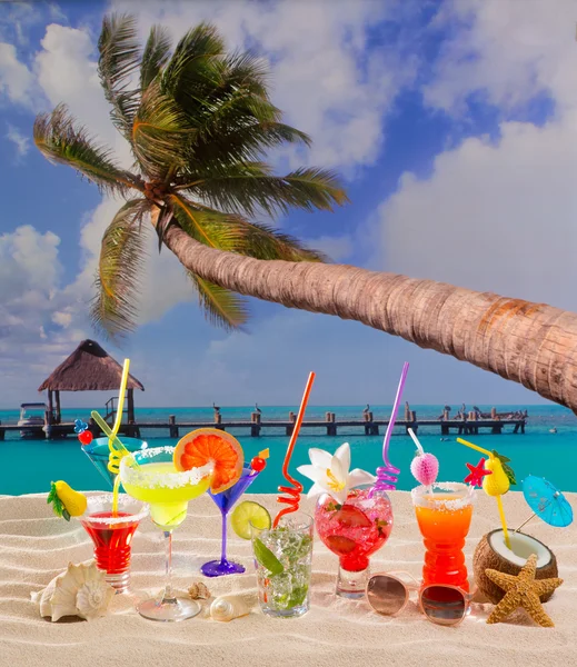 Colorful tropical cocktails at beach on white sand