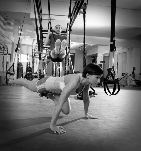 Fitness TRX training exercises at gym woman and man